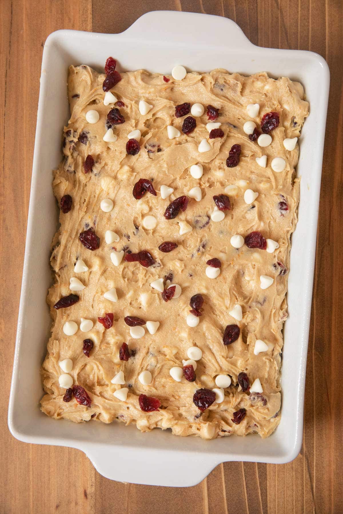 Unbaked Cranberry Orange Blondies in white baking dish