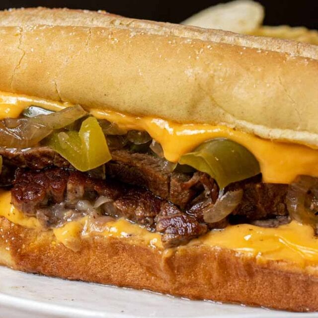 Instant Pot Philly Cheese Steak Sandwich on plate with cheese whiz
