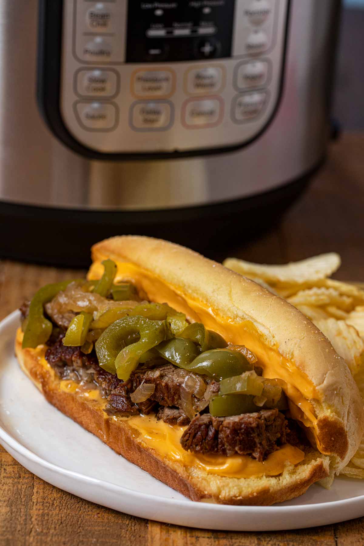 Instant Pot Philly Cheese Steak Sandwich on plate with cheese whiz