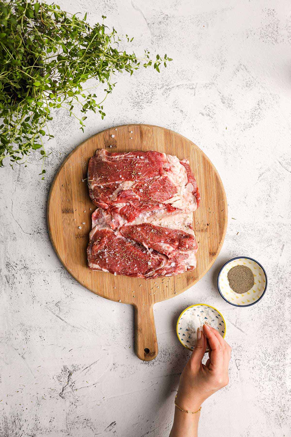 Irish Guinness Roast Lamb lamb shoulder on cutting board being seasoned