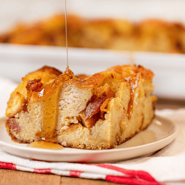Sweet breakfast dish on a white plate with syrup being drizzled on top