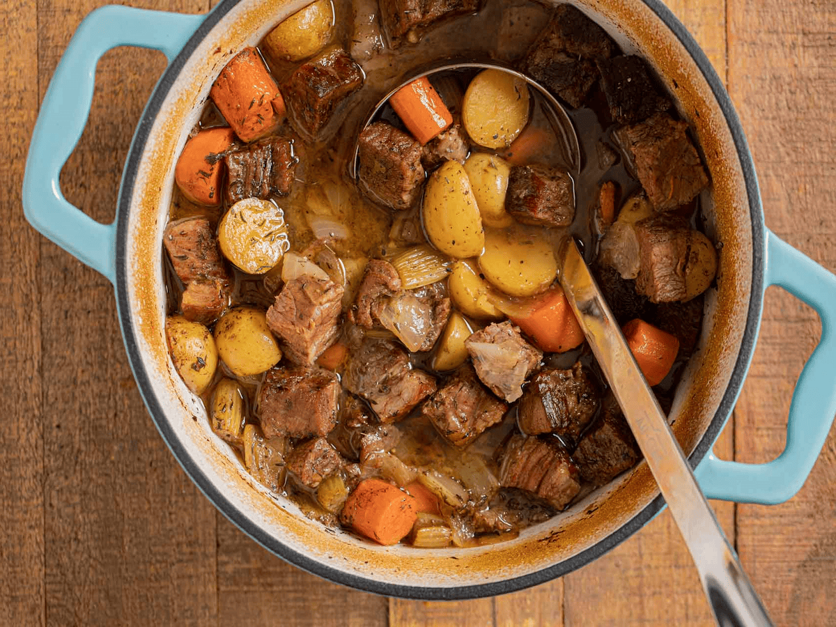 Beef roast soup in a blue pot.