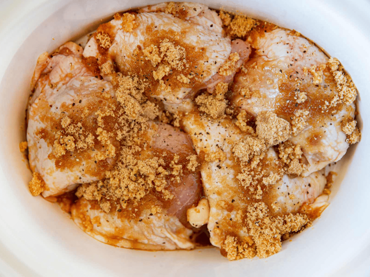 Raw poultry in slow cooker with seasoning and sugar
