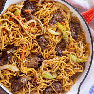 cooked meat with noodles and veggies in a pan
