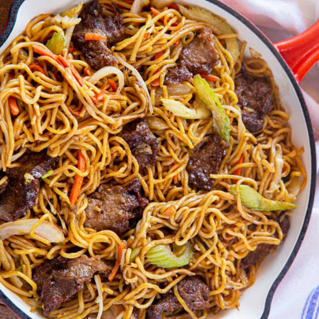 cooked meat with noodles and veggies in a pan