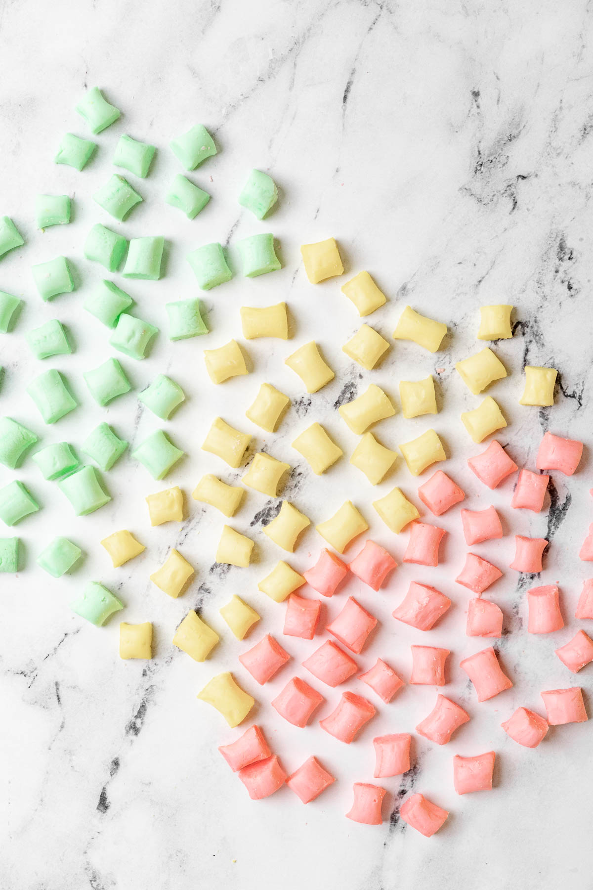 Butter Mints pink yellow and green mints on marble surface
