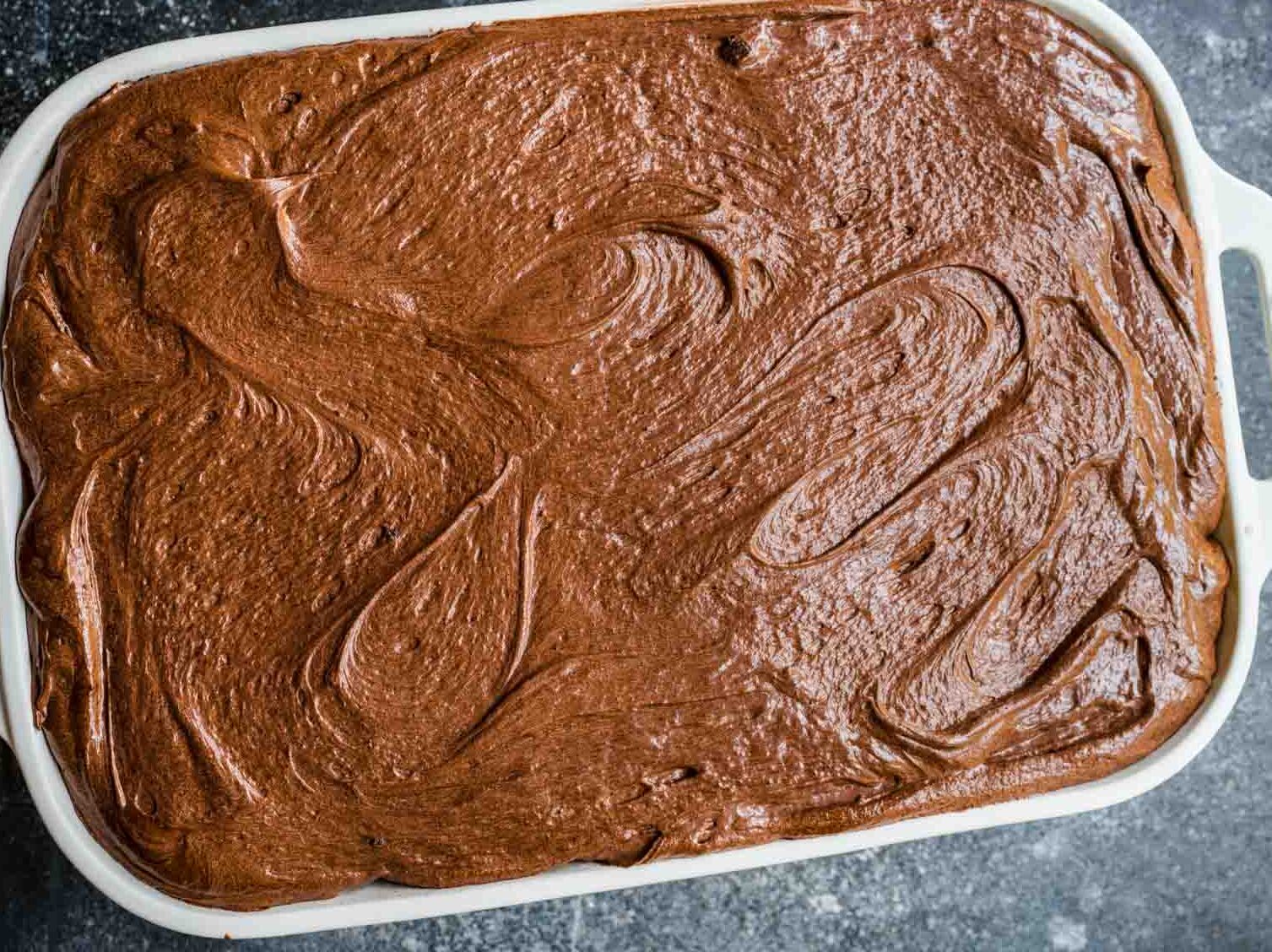 Frosted cake in pan before decorating.