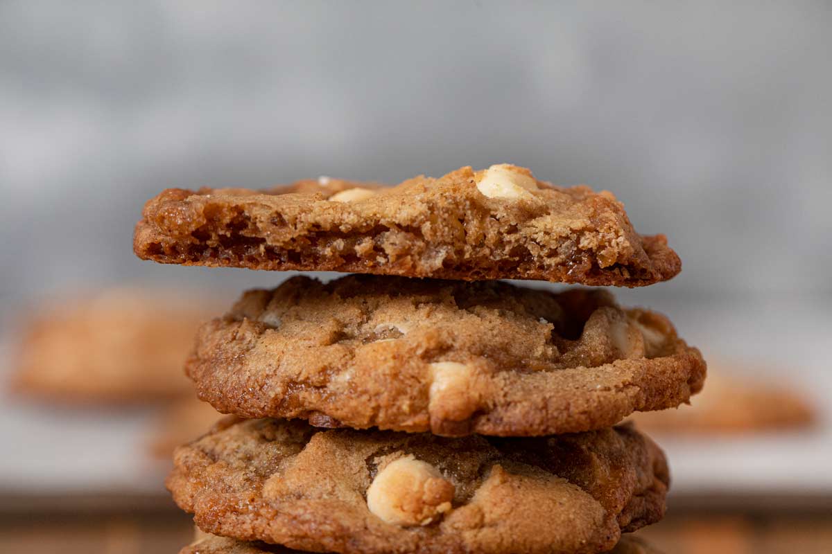 Cinnamon Crisp Cookies in stack with bitten cookie on top