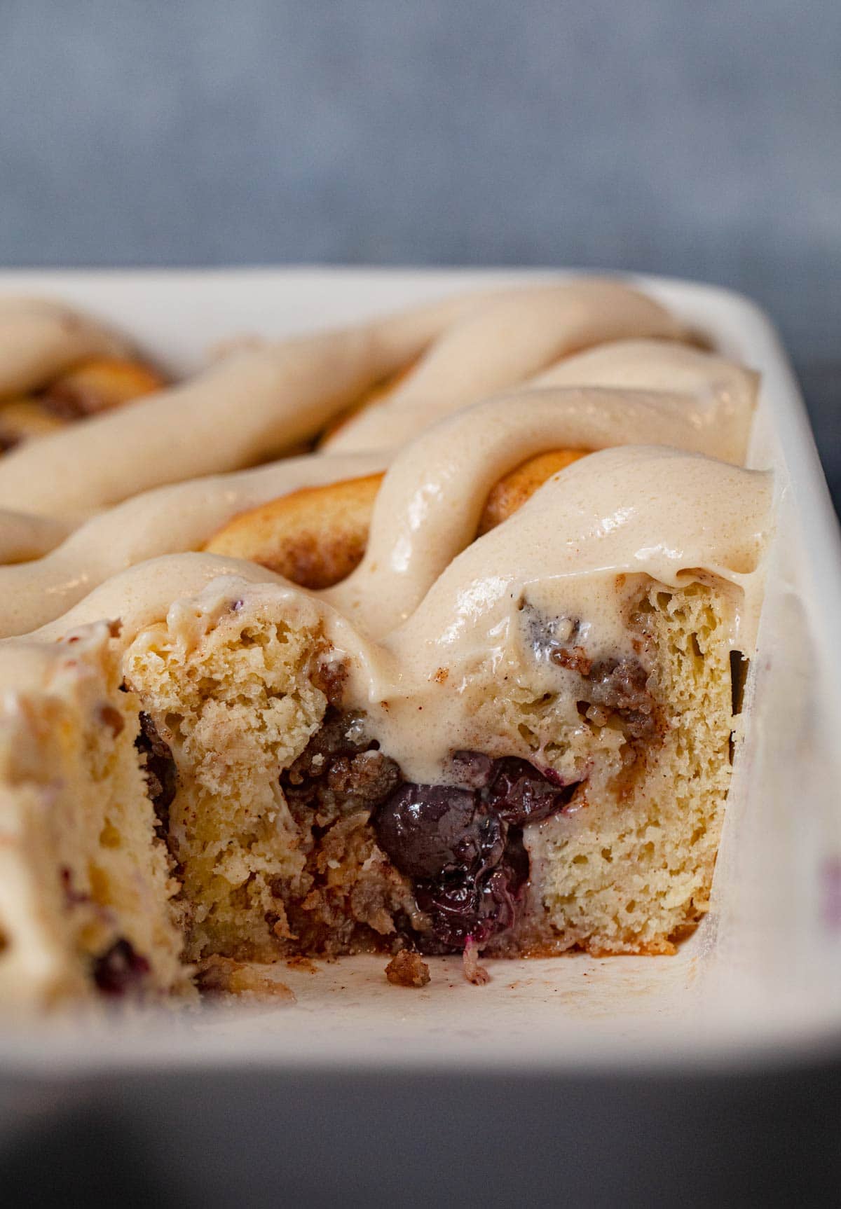 cross-section of Sausage Blueberry Cinnamon Rolls in baking dish