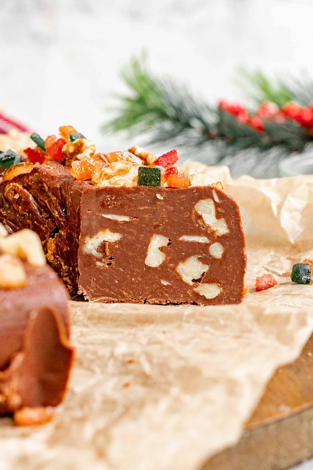 Sliced Easy Fudge Wreath served on parchment paper at holiday table.