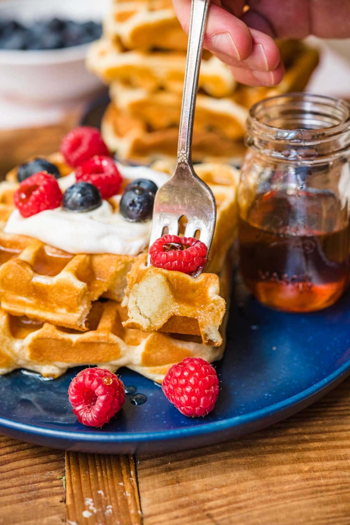 Classic Waffles on plate with whipped cream and berries