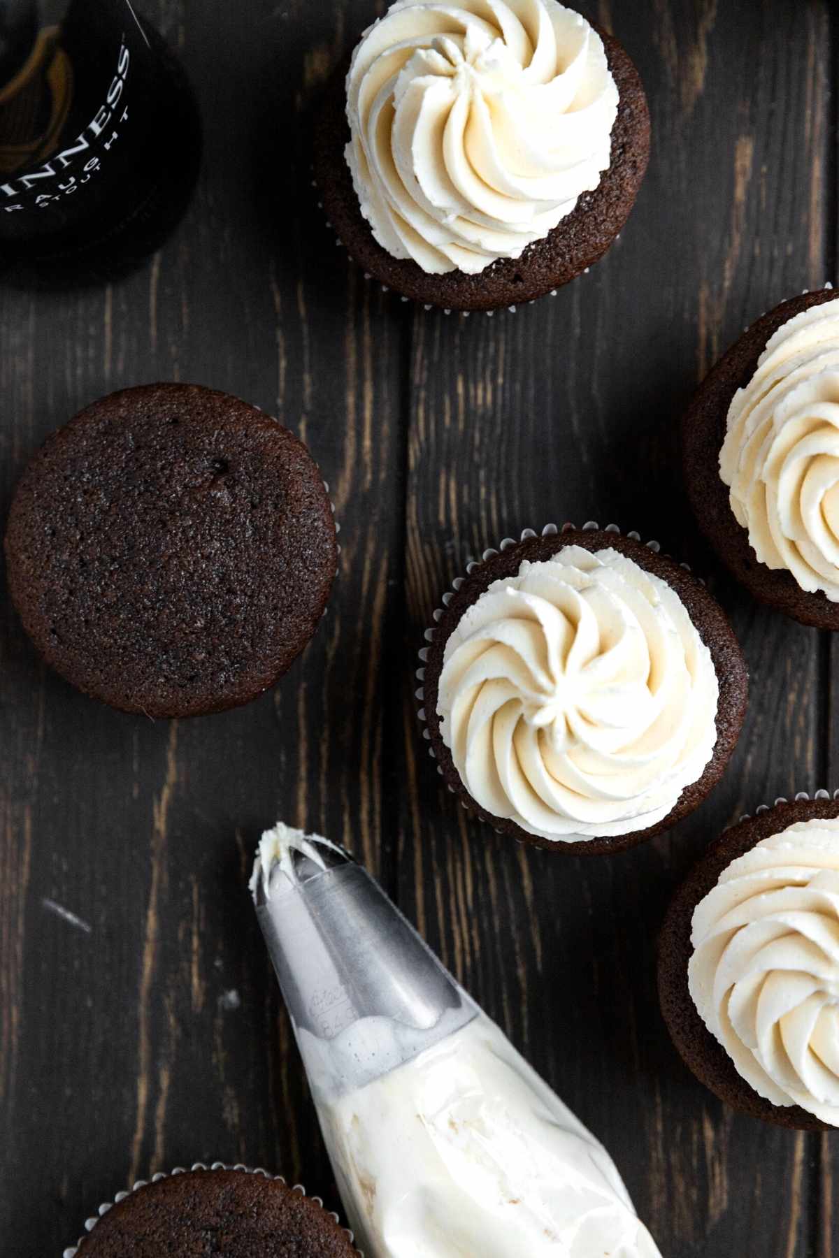 Irish Cream Guinness Cupcakes with frosting bag on cutting board
