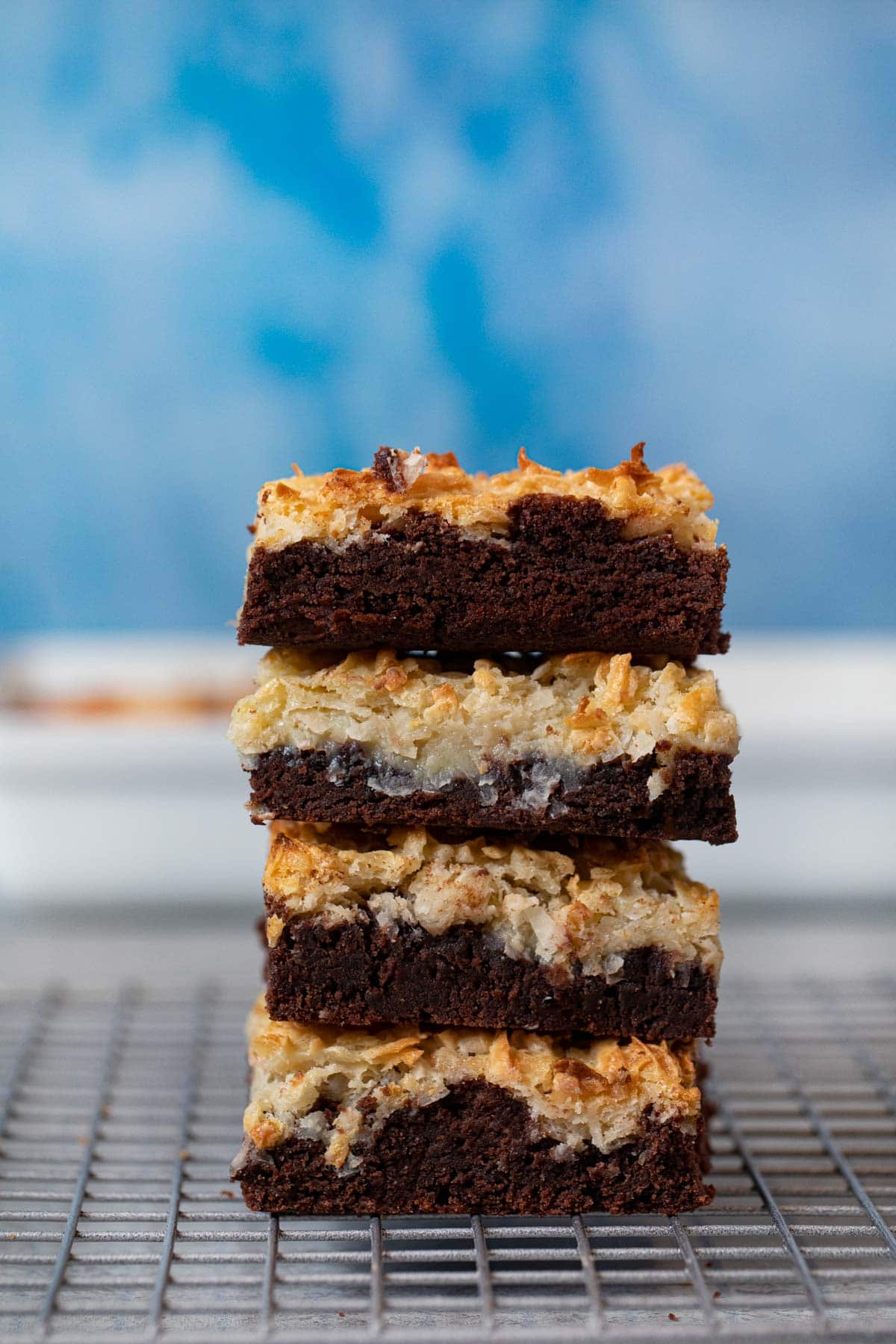 Coconut Macaroon Brownies on metal cooling rack in a stack