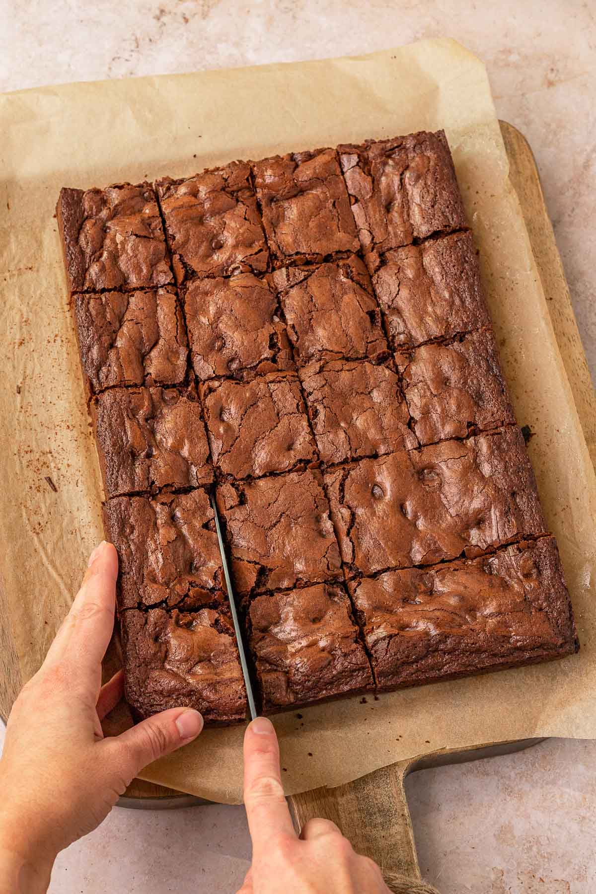 Mexican Brownies baked on parchment paper being sliced