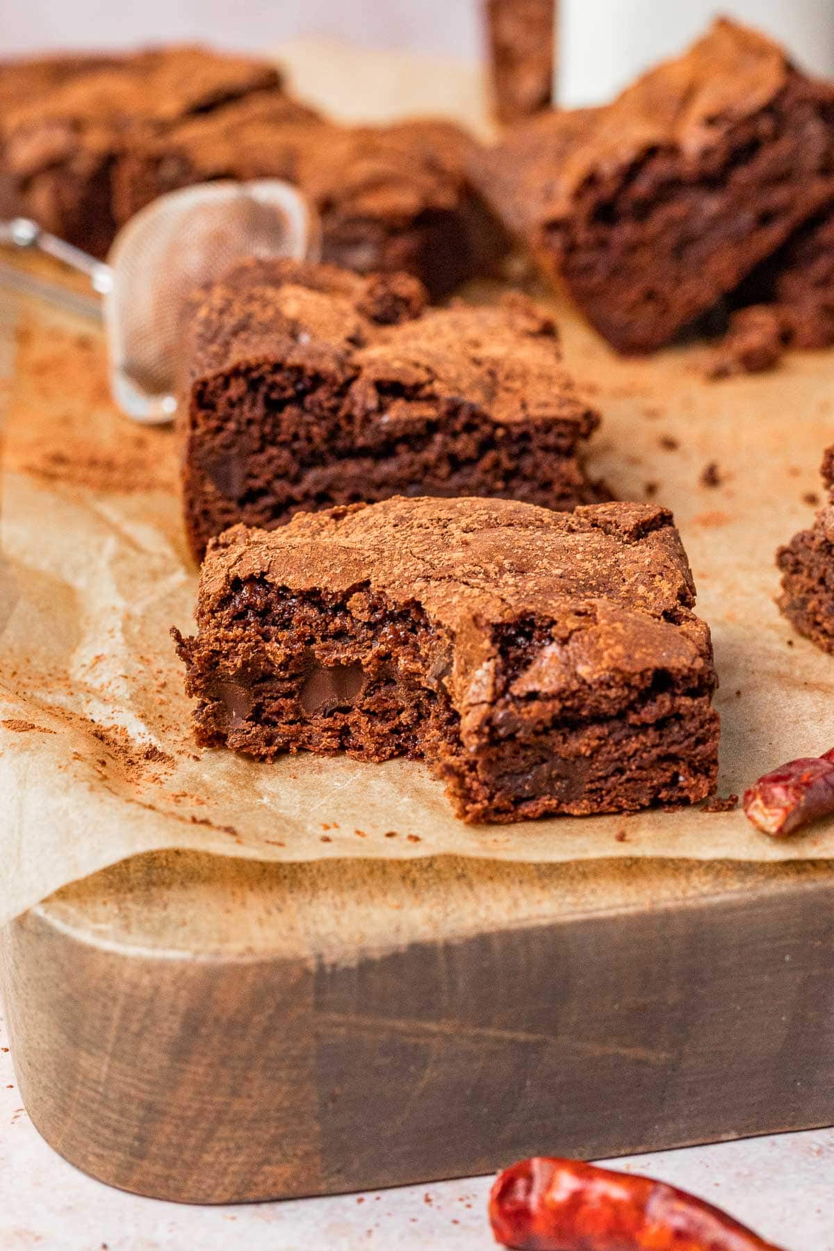 Mexican Brownies sliced close up on parchment paper one bite removed