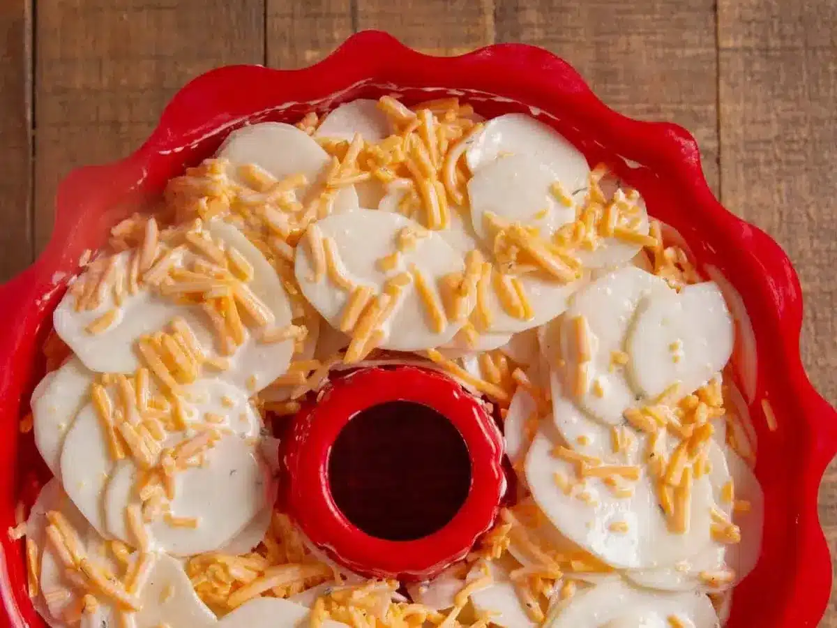 Bundt pan with potatoes and cheese layered