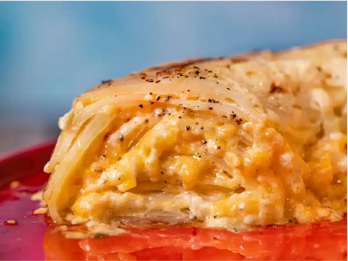 slice of scalloped potato cake on a red plate