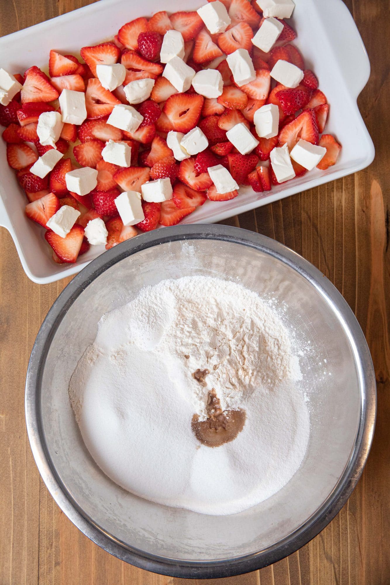 Strawberry Cream Cheese Cobbler strawberries and cream cheese in baking dish and dry ingredients in bowl