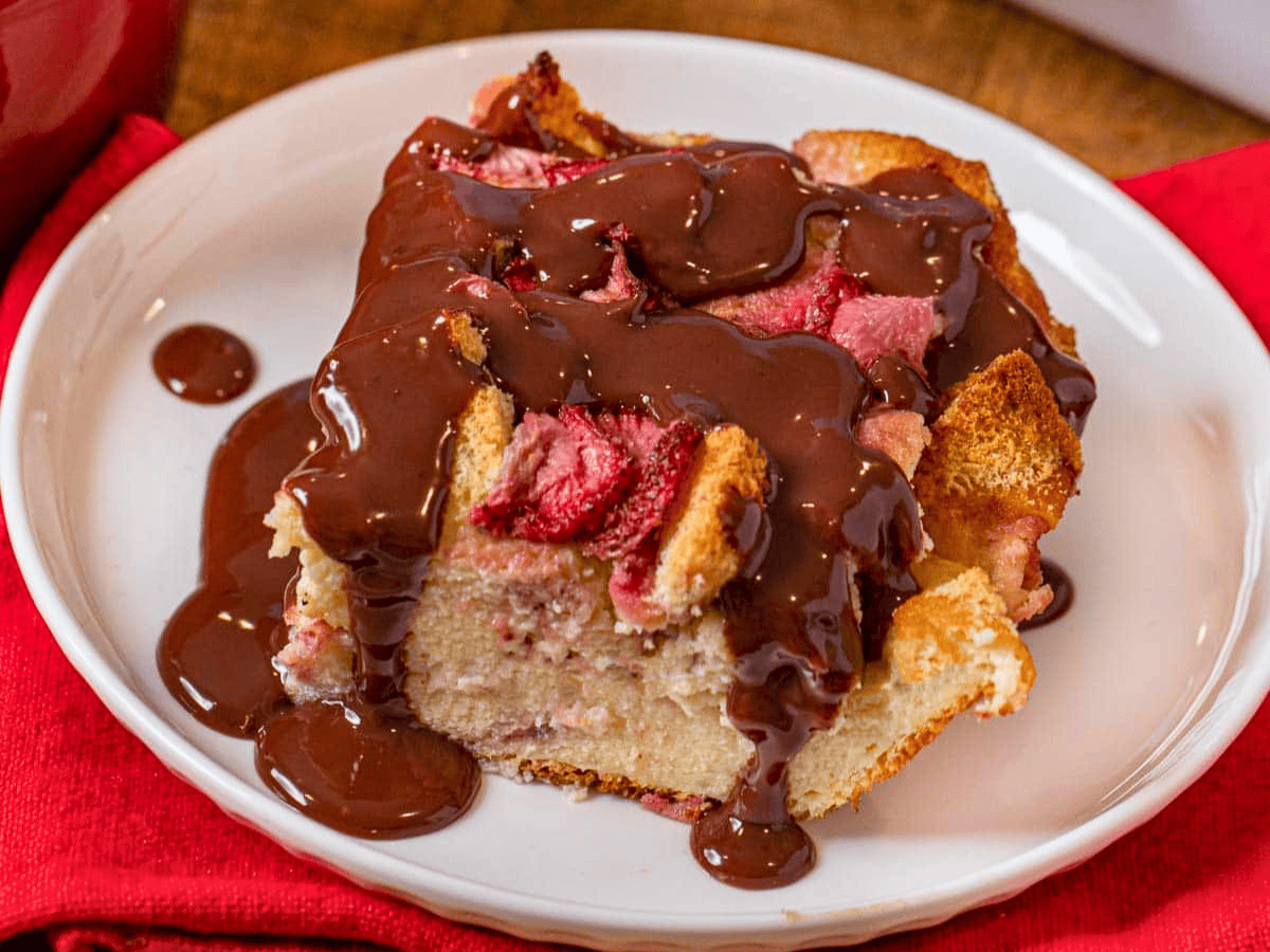 soggy bread on a plate with melted chocolate and strawberries