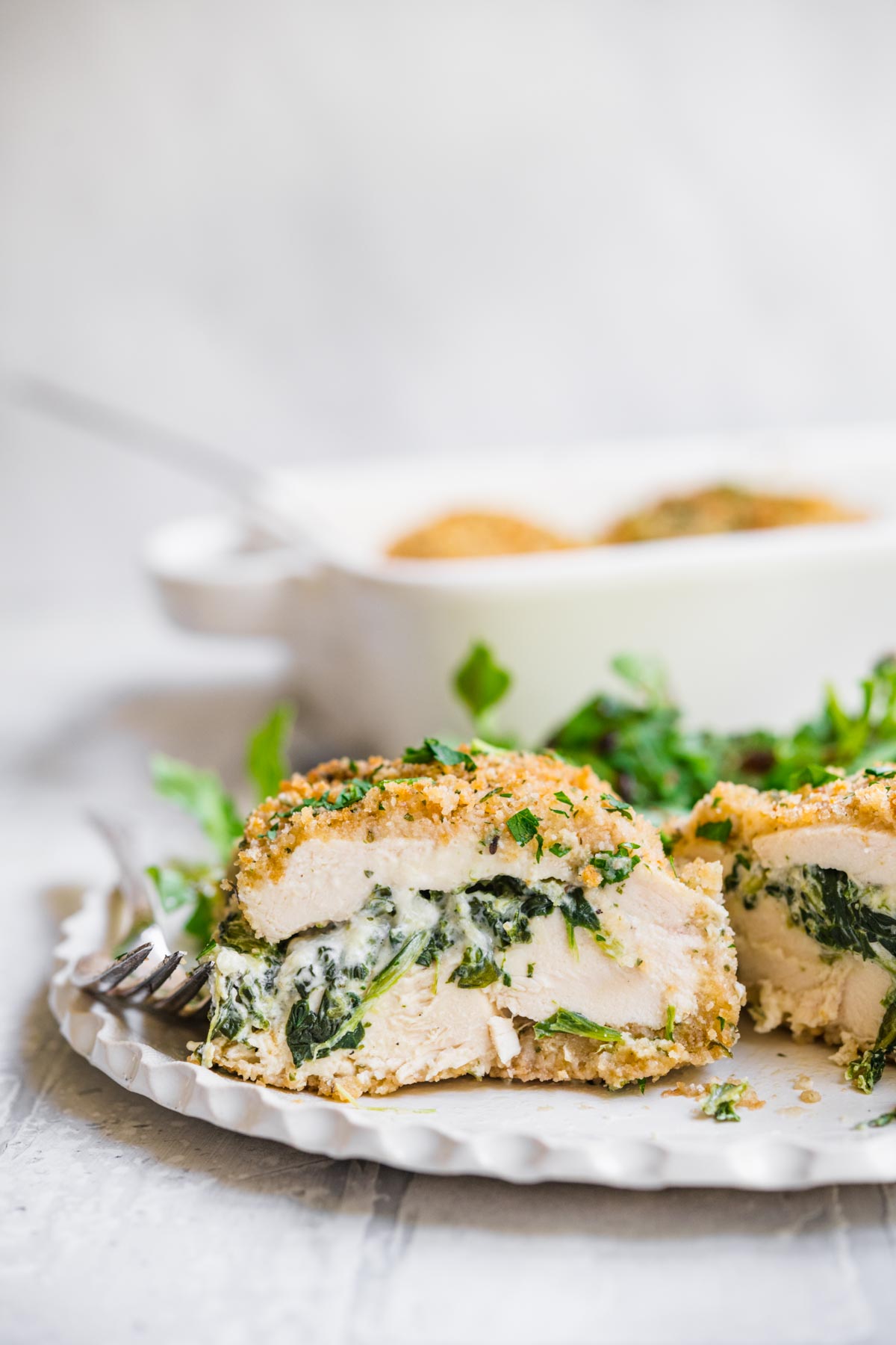 Stuffed Chicken Breast on dinner plate with salad