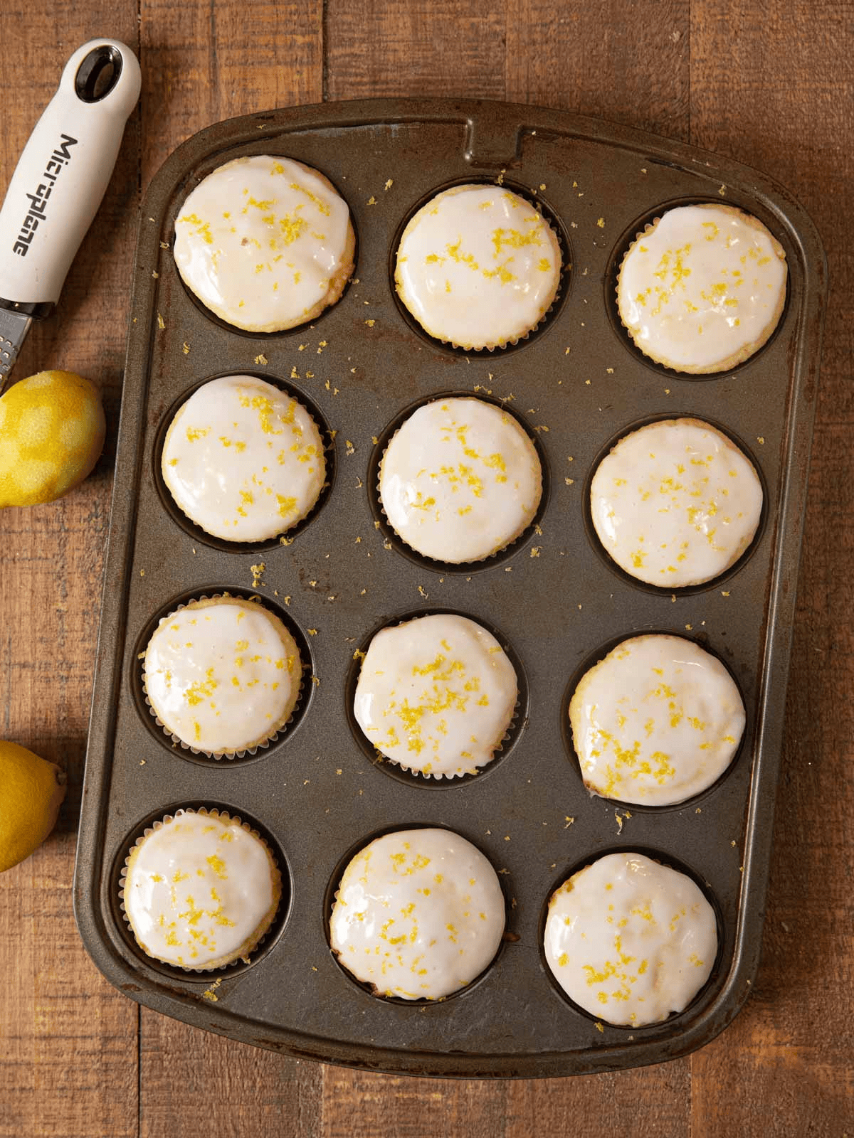 Iced muffins in a tin shown from above