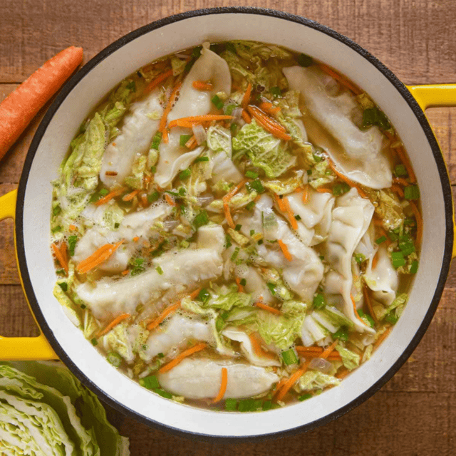 soup with vegetables and potstickers in a pot
