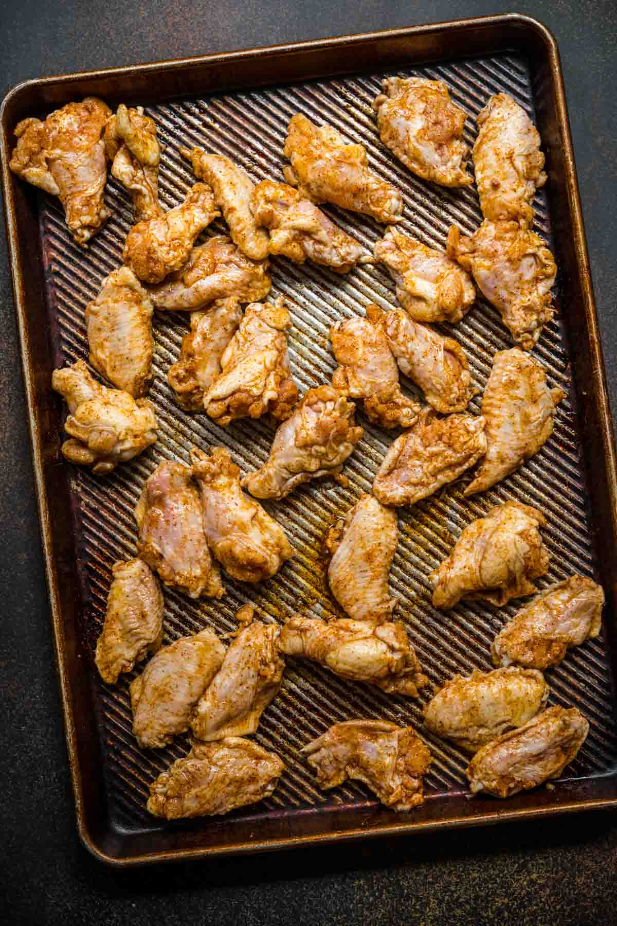 Baked Chicken Wings seasoned chicken wings on baking sheet before baking