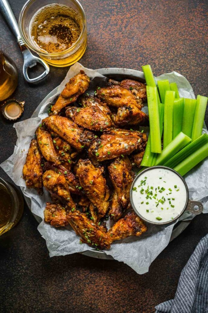 Baked Chicken Wings on serving plate with celery and creamy dip