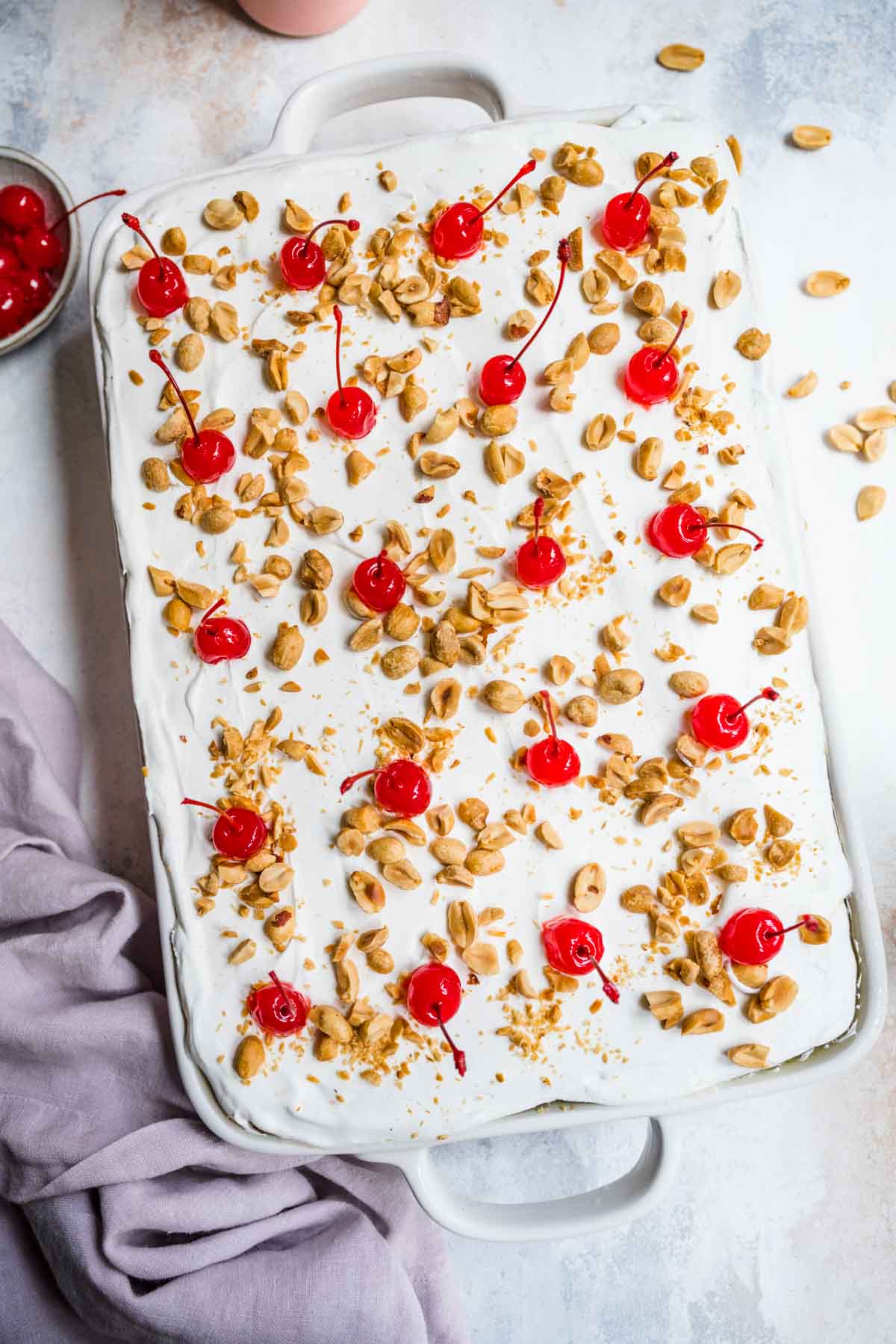 No-Bake Banana Split Dessert whipped topping, cherries and nuts on completed dish