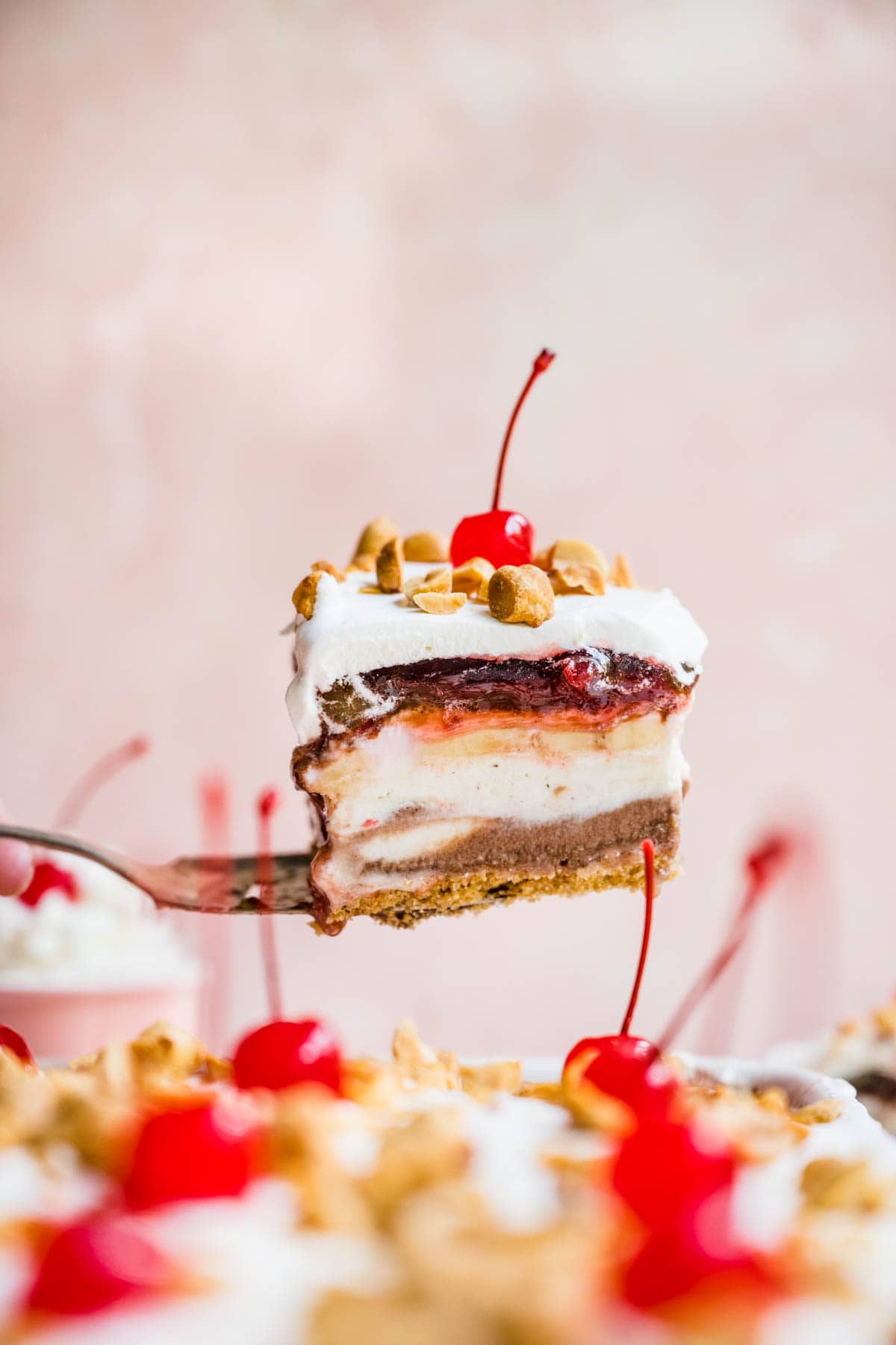 No-Bake Banana Split Dessert slice from pan showing layers