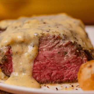 side view of sliced steak with sauce on top