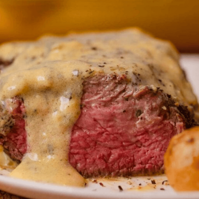 side view of sliced steak with sauce on top