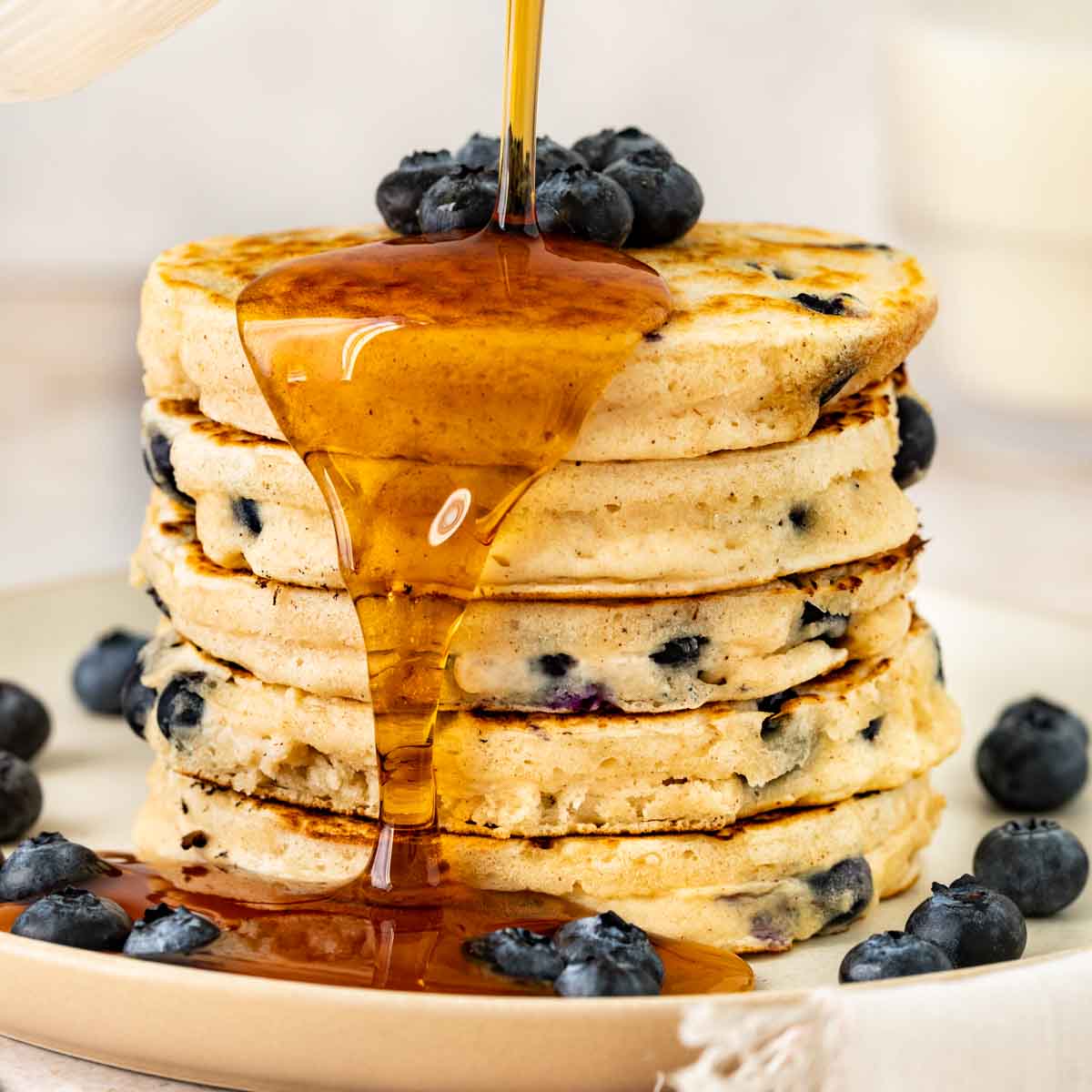 Blueberry Pancakes in a stack with syrup
