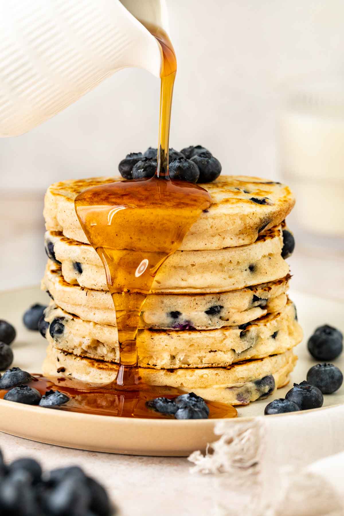 Blueberry Pancakes in a stack with syrup