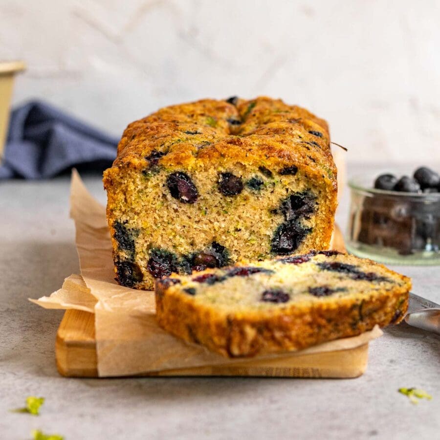 Blueberry Zucchini Bread loaf sliced on cutting board