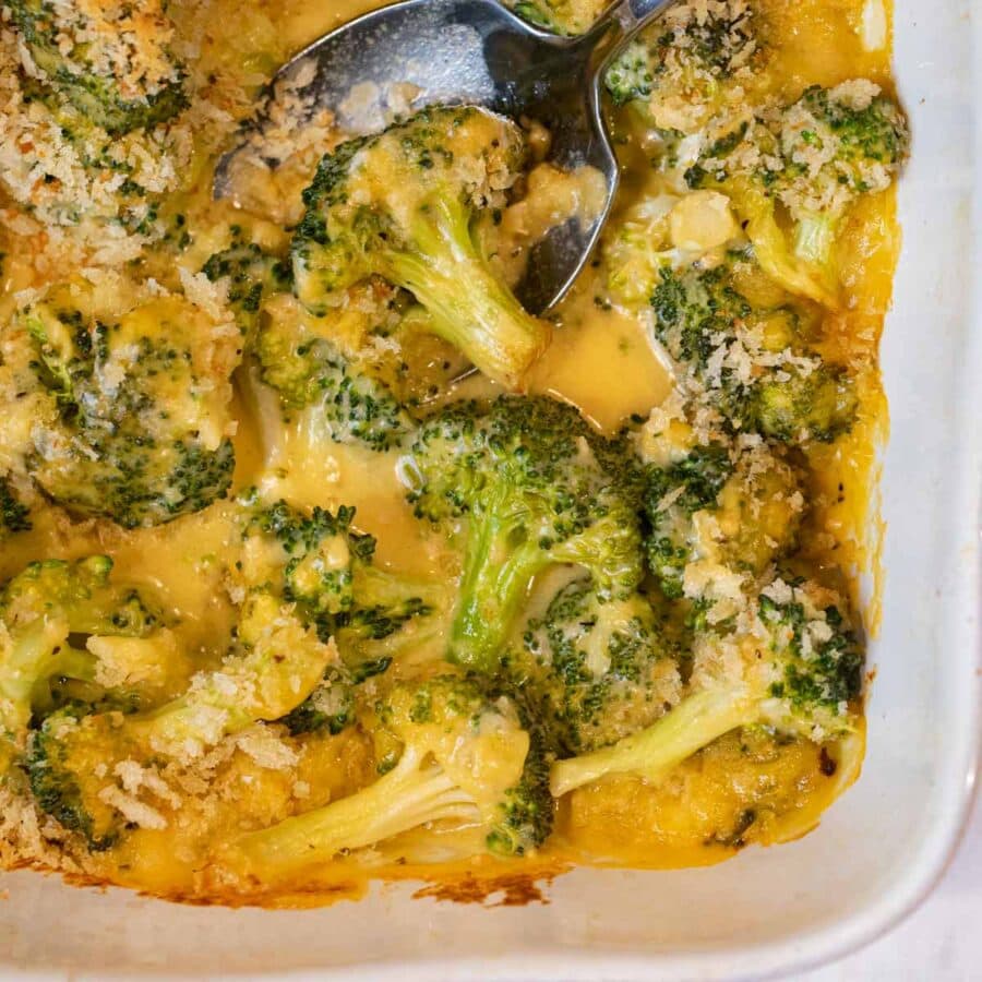 Cheesy Garlic Casserole in baking dish with spoon