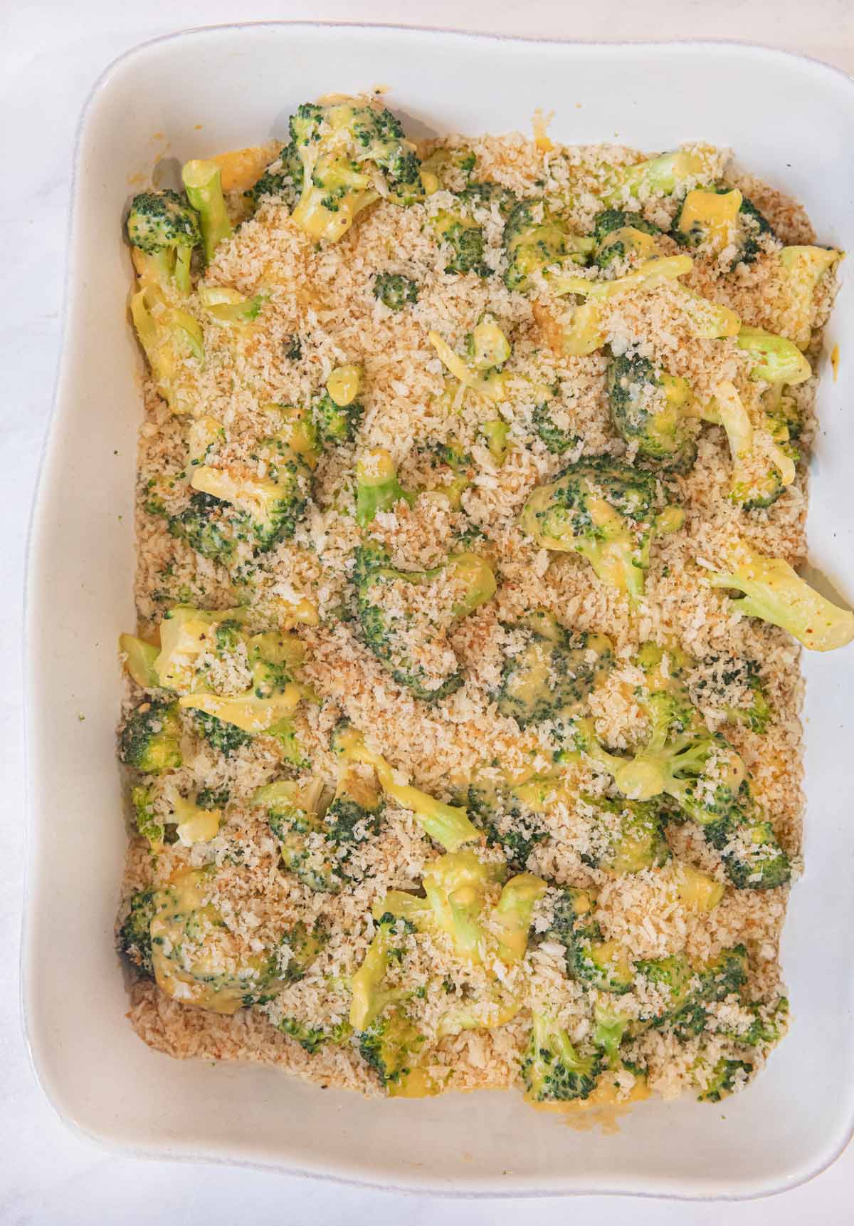 Cheesy Garlic Casserole in baking dish coated with bread crumbs before baking