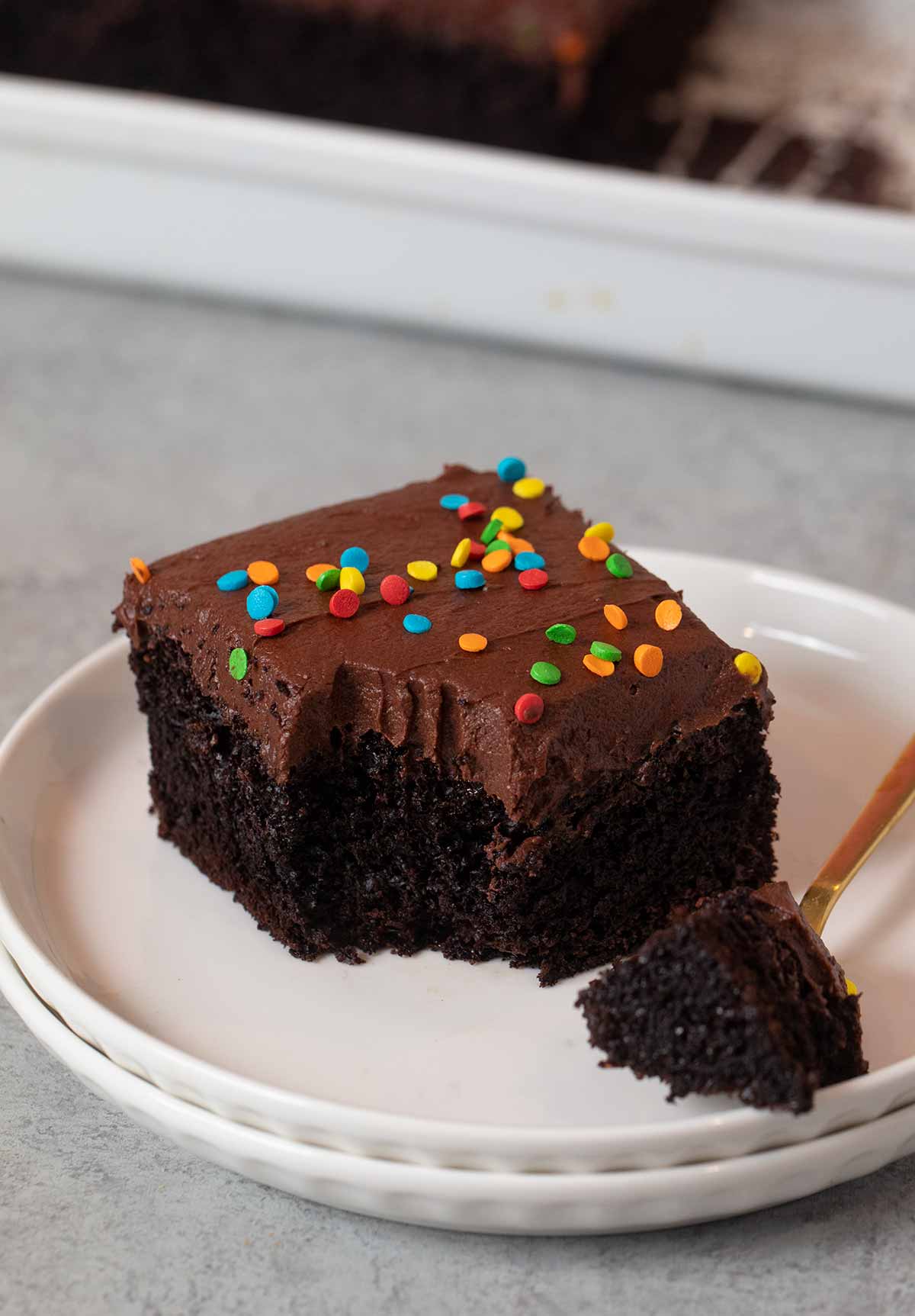 serving of Chocolate Sheet Cake on plate with bite on fork