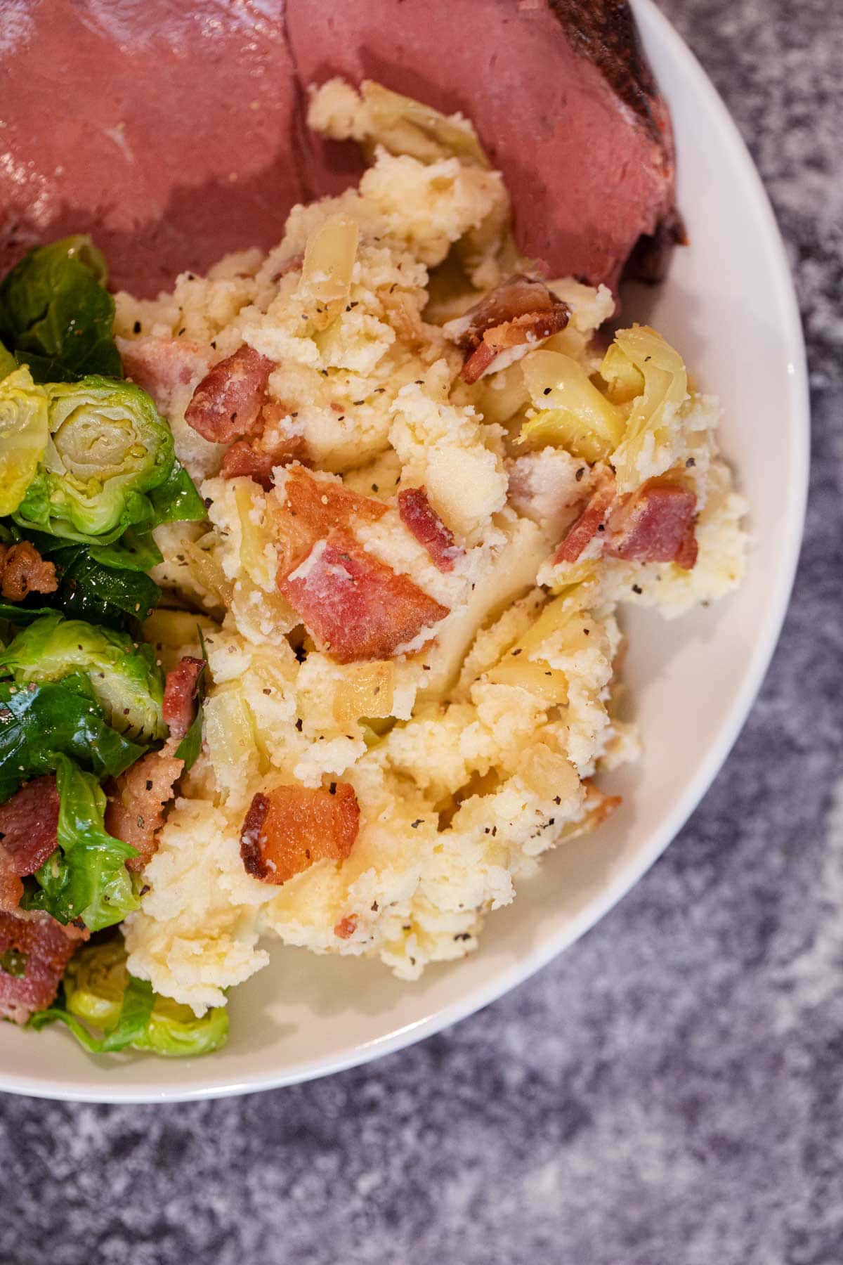 Colcannon Irish Potatoes on plate with ham and Brussels sprouts