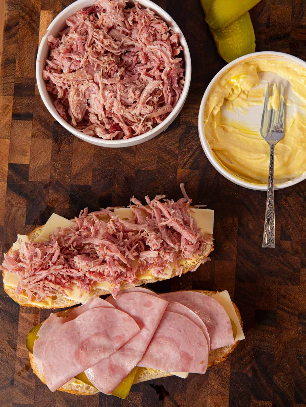 Cuban Sandwich being assembled on cutting board