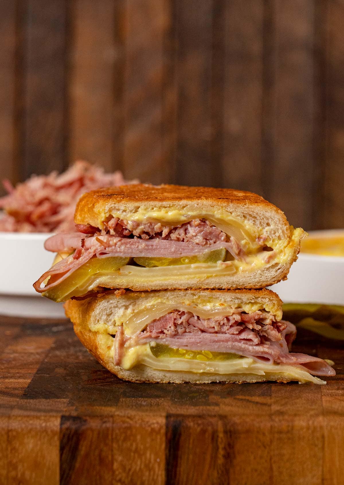 Cuban Sandwich halves stacked on cutting board