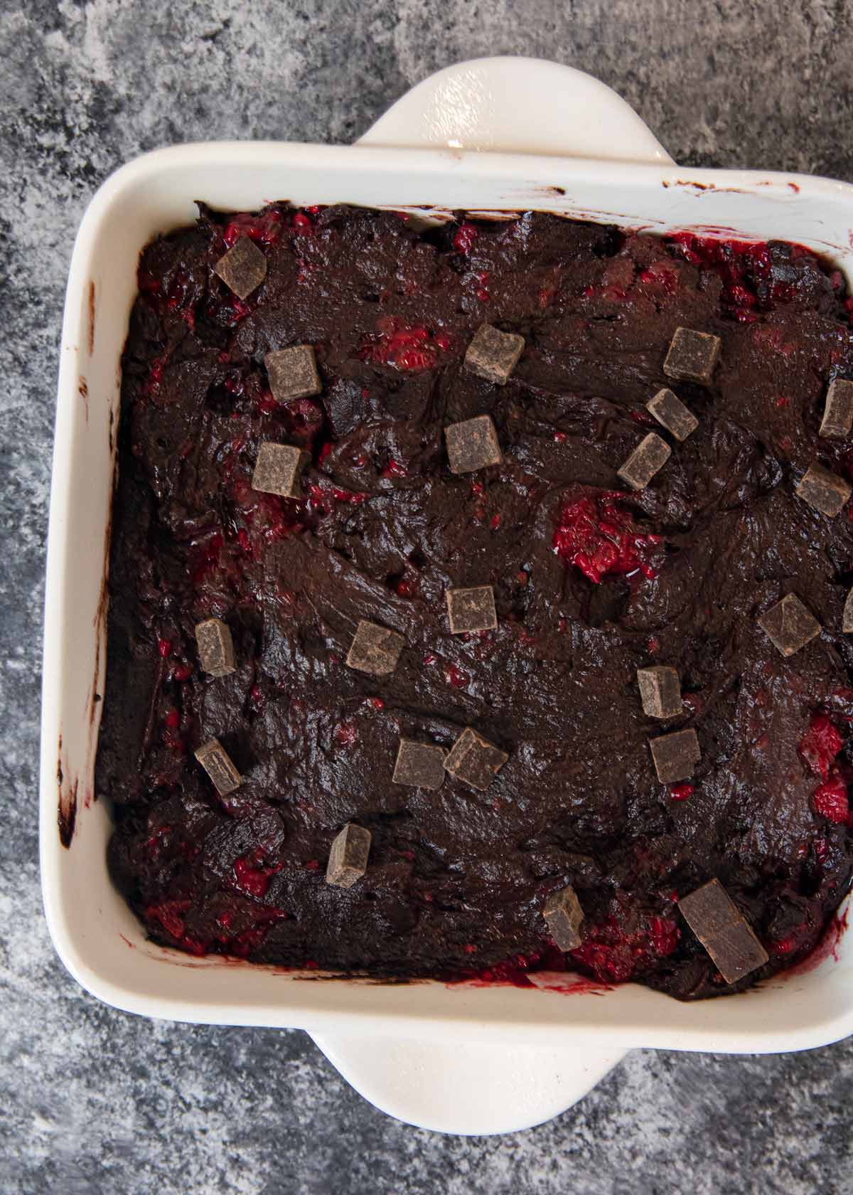 Dark Chocolate Raspberry Brownies batter in baking dish