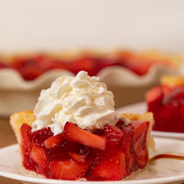 Fresh Strawberry Pie slice on plate with whipped cream