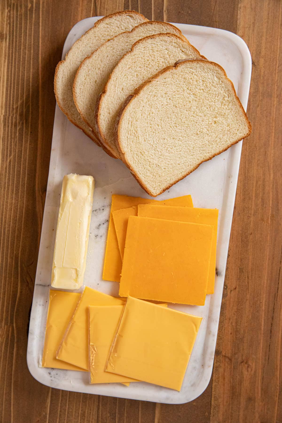 Grilled Cheese Sandwiches bread, cheese, and butter on cutting board
