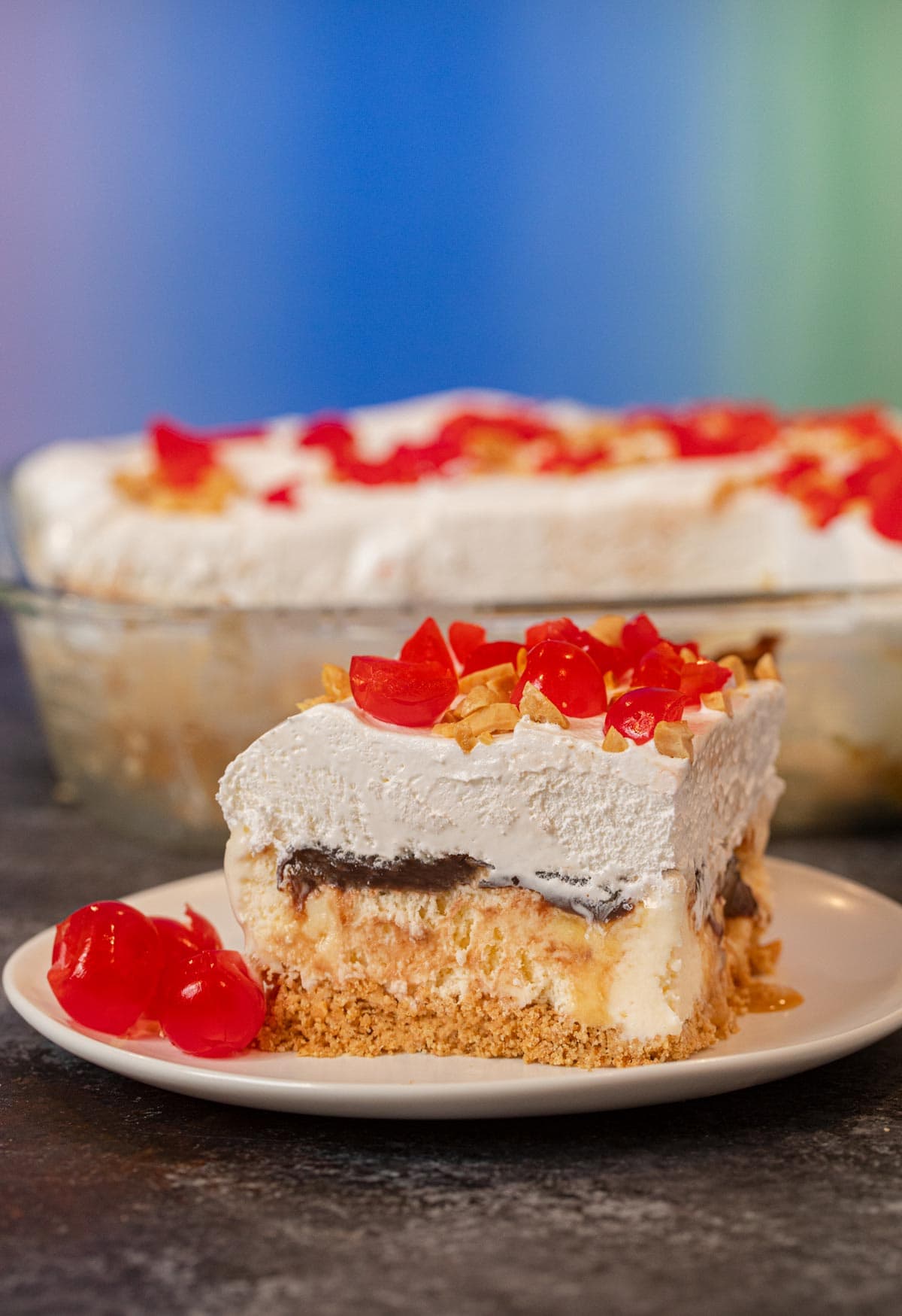 Ice Cream Sundae Casserole serving on plate with maraschino cherries