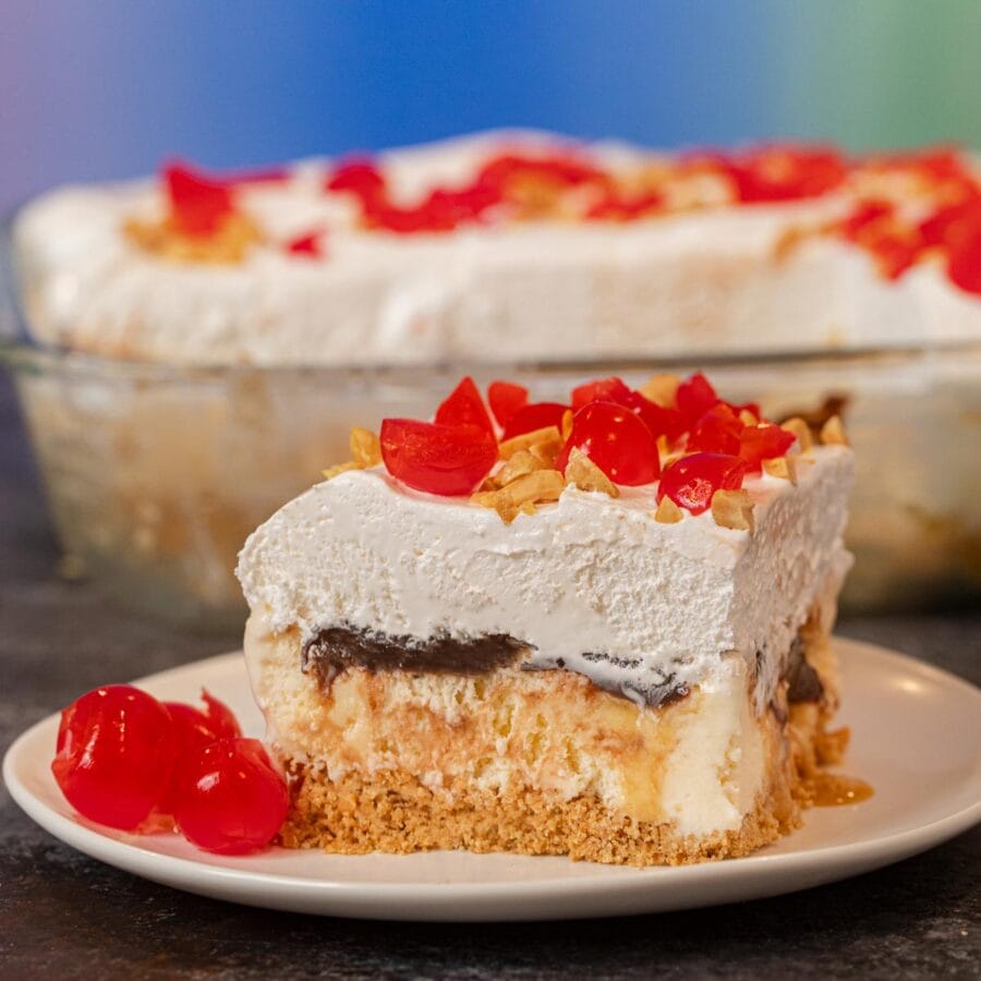 Ice Cream Sundae Casserole serving on plate with maraschino cherries