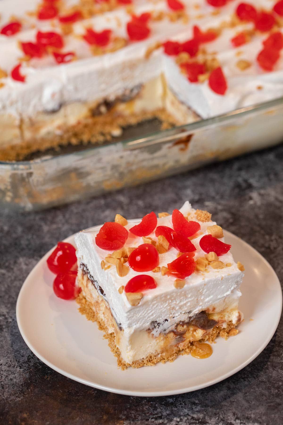 Ice Cream Sundae Casserole serving on plate with maraschino cherries