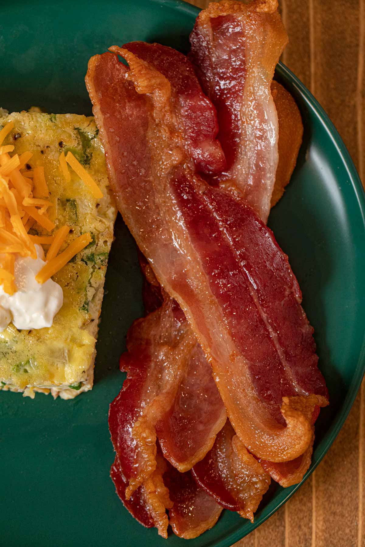 Oven Baked Bacon on plate with eggs