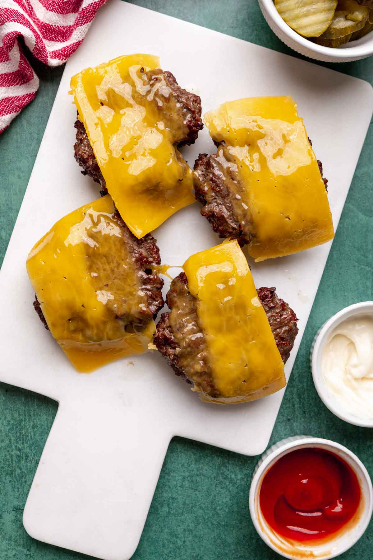 four cooked Oven-Baked Burgers with cheese