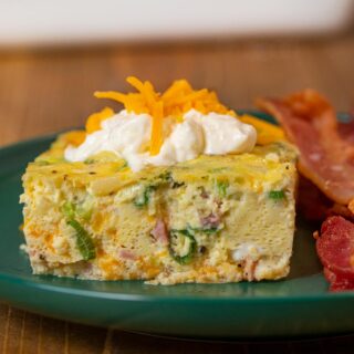 serving of Oven-Baked Omelette on plate with sour cream and bacon
